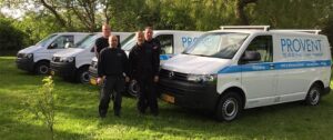 Provent team standing beside company service vans